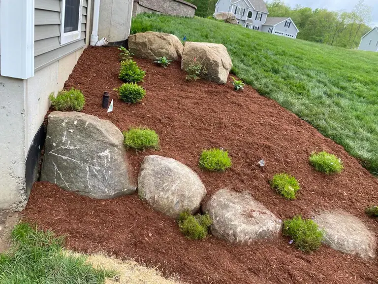 Boulder edging on a planted slope